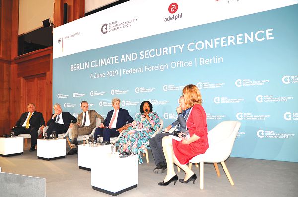 Ms Shirley Ayorkor Botchway (with microphone) speaking at the Berlin Climate and Security Conference. On her right is Mr John Kerry and Maja Gopel (right), the moderator of the conference 