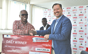 Mr Kofi Dwomo Amadieh (left) receiving a cash prize of GH¢1,000 from Mr Jorge Osoro, Group Sales and Marketing Director, Devtraco