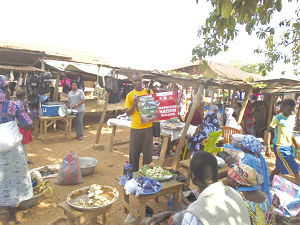 Mr Daniel Agbesi Latsu (arrowed), NCCE District Director, addressing the market folk