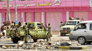 Sudanese soldiers stand guard a street in Khartoum on June 9.