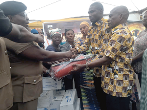Dr Dominic Eduah (2nd right), the Executive Director of GNPC Foundation, presenting the extinguishers to DO 1 Konney