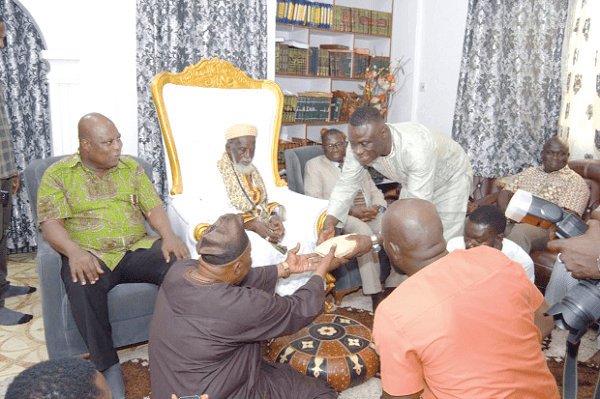 Mr Kofi Ofori making a cash presentation to an aide to the National Chief Imam. Looking on is Sheikh Alhaji Nuhu Sharubutu (arrowed) and Mr Ashitey (left)