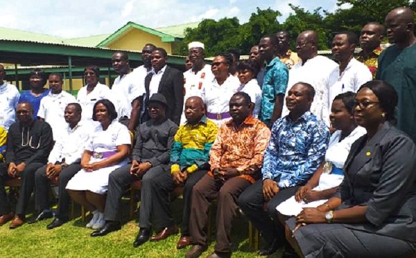Mr Kwaku Agyemang-Manu (seated middle) and Mr John Peter Amewu with some officials of the Ho Teaching Hospital