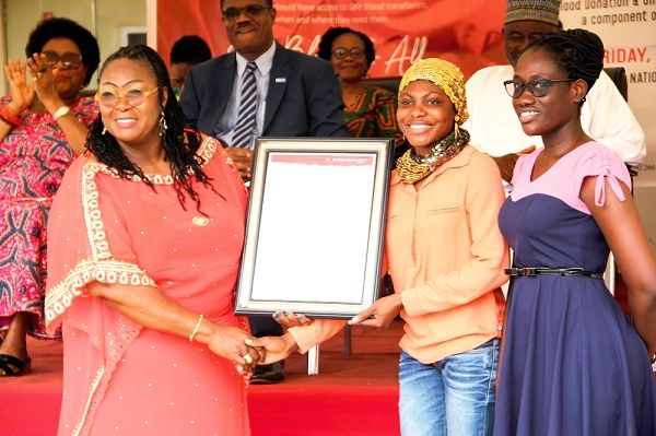 Madam Tina Mensah (left) presenting a citation of appreciation to representatives of the Ghana Institute of Journalism (GIJ) for being donors. Picture: EDNA ADU-SERWAA
