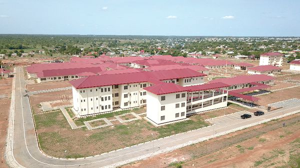 An aerial view of the Wa Regional Hospital. INSET: Mr Abhilash Sadanadan (right), an engineer at Euroget-De Invest, briefing our reporter (left) on the operations of the Biosafety Cabinet at the central laboratory