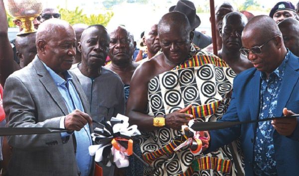 The Asantehene, Otumfuo Osei Tutu II (in Kente), being assisted by Mr Patrick Akorli (right) to cut the ribbon for the inauguration of the GOIL office complex in Kumasi. Those looking on include Mr Kwame Osei Prempeh (2nd left). Pictures: EMMANUEL BAAH 