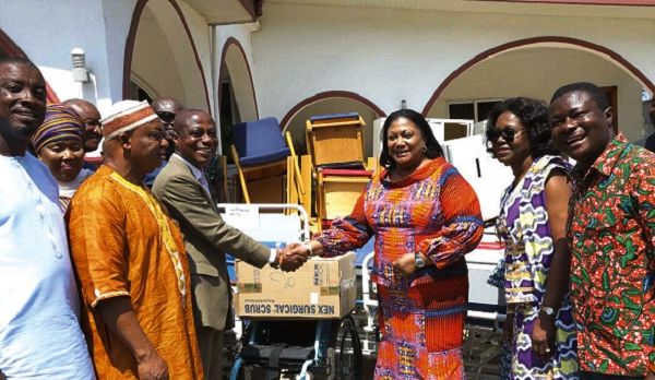 Mrs Akufo-Addo (third right), in a handshake with Mr Kofi Okyere-Agyekum, MP for Fanteakwa South Constituency. Looking on is Alhaji Mohammed Adel Samed Gunu (2nd left), MP for Savulugu