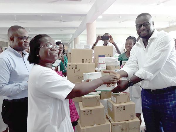 Mr Frank Annoh-Dompreh presenting medical materials to Mrs Grace Attah-Adjepong, Head of Pharmacy at the Nsawam Government Hospital