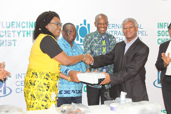 Mrs Joy Otabil (left), presenting a electroconvulsive therapy machine to Dr Akwasi Osei(right), Executive Director of Mental Health at the 35th Anniversary of  the ICGC Temple among them are Rev. Morris Appiah (2ndleft), Rev Christopher Annor. PICTURE BY PATRICK DICKSON