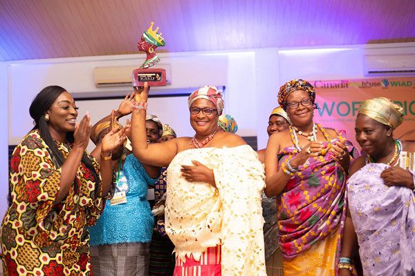 The queenmother of Abutia Kloe, Mama Ayipe, with her Royal Agro award while CEO of Sidalco, Rev. Mrs Gifty Lamptey (left) cheers her on