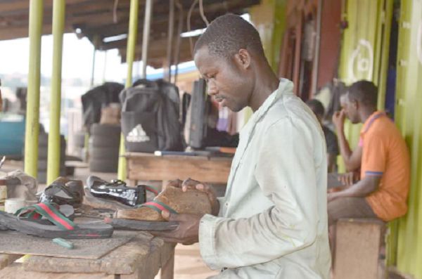A ‘shoe maker’ at work at the Asafo shoe-making hub