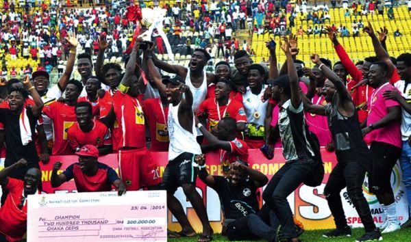 Asante Kotoko captain, Amos Frimpong lifts the trophy amid wild celebration by his teammates. Picture Emmanuel Baah