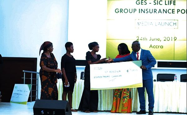 Ms Ivy Adwoa Asiedu, wife of the Late Mr George Bosompem, (3rd right) receiving the cheque from Prof. Opoku-Amankwa, and Mrs Wyns-Dogbe at the ceremony. Picture: PATRICK DICKSON
