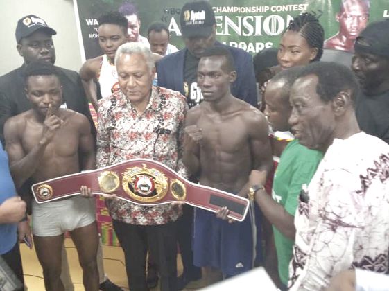 Wasiru (left) and Japhet in a pose with the WBO Africa Super Bamtaweight title after yesterdy’s weigh-in