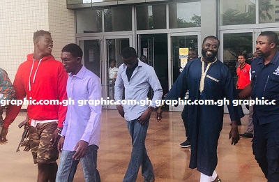 The accused persons leaving the court premises