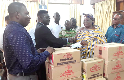 Dr Sarfo Adu (left) presenting the cheque and the items to Nana Agyeiwaa Kodie