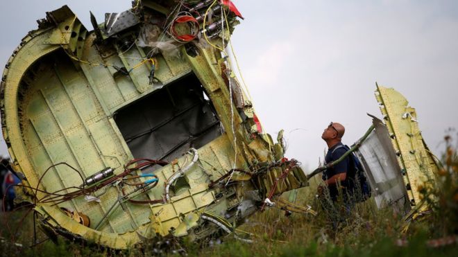 An investigator inspects the wreckage of Malaysia Airlines Flight MH17 