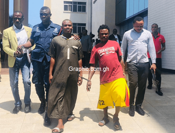 Safianu Abubakari (red shirt) and Abdul Rahman Suleiman, being escorted out of the court premises