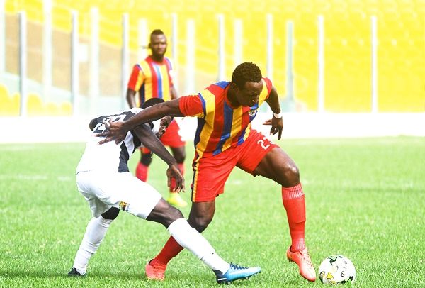 Hearts of Oak striker, Kofi Kodzi (right), attempts to dribble past his Dream FC marker. Picture:  EBOW HANSON