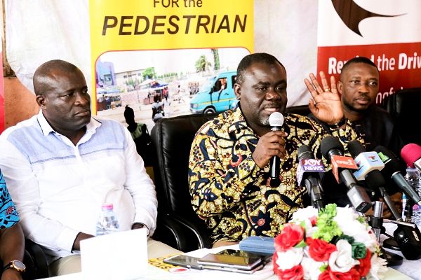 Mr Kwaku Ofori Asiamah (middle), Minister of Transport, delivering his address. With him are Mr Titus Glover (left), Deputy Minister of Transport, and Mr Ishmala Awudu, Board Chairman, National Road Safety Commission