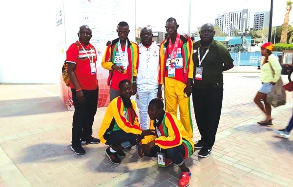 Joseph Tettey Amertowosi (second left) and Hannah Dantakor (squatting left) with other athletes and officials after winning gold.