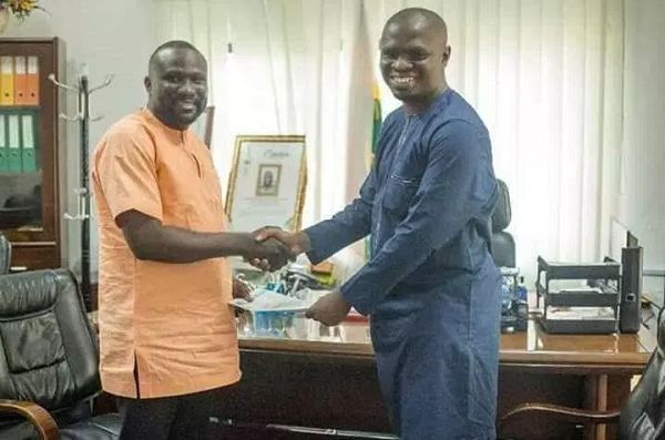  Mr Mustapha Ussif (left) presenting documents on the maize to Mr Abdul-Wahab Hanan