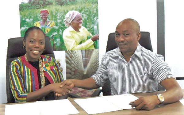 Ms Abena Osei Poku in a handshake with Mr D. Kadri Alfah, CEO of GCX