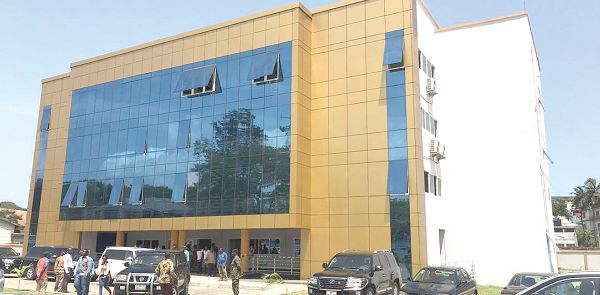 The new building for library and office.  Inset: Hajia Alima Mahama (middle) being assisted by Mr John Davis (2nd right), Mr K.K. Sam, (3rd right) and Mr Kojo to inaugurate the building