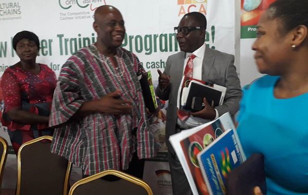  Mr Seth Akoto (right), the Director of Crop Service at the Ministry of Food and Agriculture, interacting with a Deputy Minister of Local Government and Rural Development, Mr Collins Ntim, after the opening ceremony