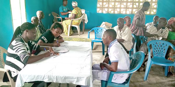 Community members going through the health screening process  