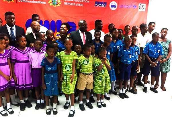 Some of the schoolchildren in a pose with a Deputy Minister of Communications, Mr Vincent Sowah Odotei (arrowed) and some other dignitaries.