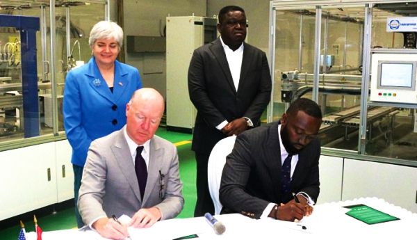 Mr Tod Skinner of AEG International and Mr Oheneba Ofori Boateng (right) signing the agreement, while Ms Stephanie S. Sullivan, the US Ambassador to Ghana, and Dr Francis Akuamoah Boateng, Chairman of Strategic Security Systems, look on. Picture: DELLA RUSSEL OCLOO