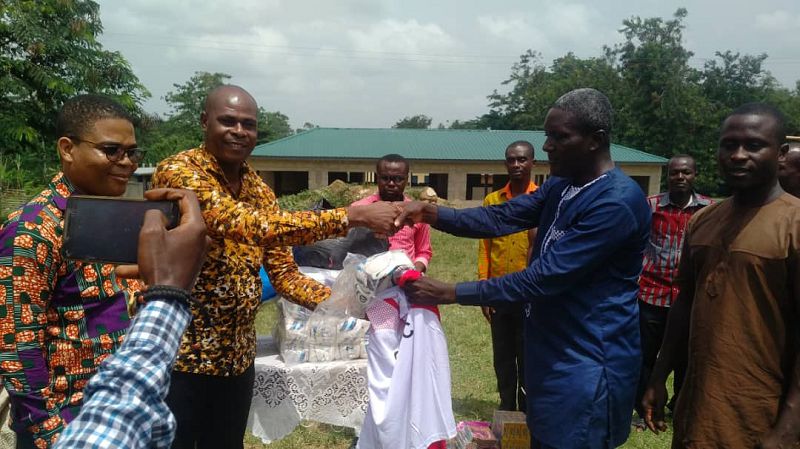 The Finance officer of the Ghana Tourism Development Company, Mr Paul Sowah (left) presenting the items to the District Chief Executive of Assin Manso South, Mr  Derrick Owusu Ambrose on behalf of the school. 