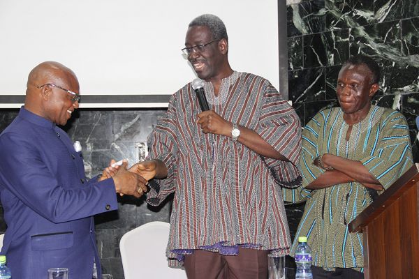 Nana Agyekum Dwamena (2nd right), the Head of Civil Service performing a symbolic transfer of staff by presenting a pen drive containing the required data to Dr Nana Ato Arthur (left), the Head of Local Government Service, at the event. With them is Mr Lawrence Dakurah (right), the Chief Executive Officer, Land Use and Spatial Planning Authority (LUPSA). Picture: EDNA ADU-SERWAA