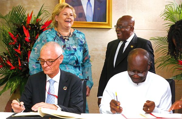 Mr Gunnar Holm (left), Norwegian Ambassador with Ken Ofori Atta (right), Finance Minister, signing an MoU as President Akufo-Addo and Erna Solberg (left), look on. Picture: SAMUEL TEI ADANO