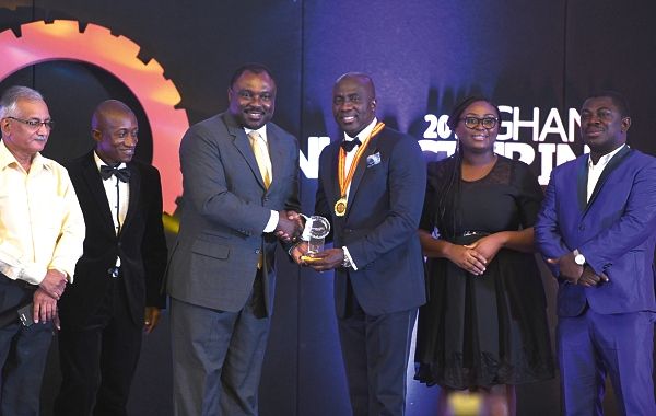 Mr Robert Ahomka-Lindsay (2nd left), a Deputy Minister of Trade and Industry, presenting the Entrepreneur of the Year Award to Mr Samuel Amo Tobbin (2nd right), Executive Chairman, Tobinco Pharmaceutical Company Limited. With them are some staff members of the Tobinco Group