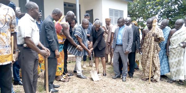 Mr Antwi-Boasiako (in smock) being assisted by Osabarima Agyare Tenadu and Ms Gifty Dechem to cut the sod for the new court buildings