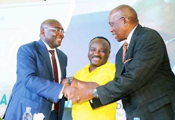 Vice President Dr Mahamadu Bawumia (left) interacting with Mr Henry Kerali (right), at the launch of Ghana’s Public Procurement System in Accra. Looking on is Mr Adjenim Boateng Adjei, Chief Executive Officer of the Public Procurement Authority. Picture: GABRIEL AHIABOR