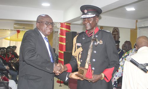  Mr Ambrose Dery (left),  presenting the Ceiling Hook to Mr Edwin Ekow Blankson, the Chief Fire Officer at the induction church service in Accra. Picture: Gabriel Ahiabor