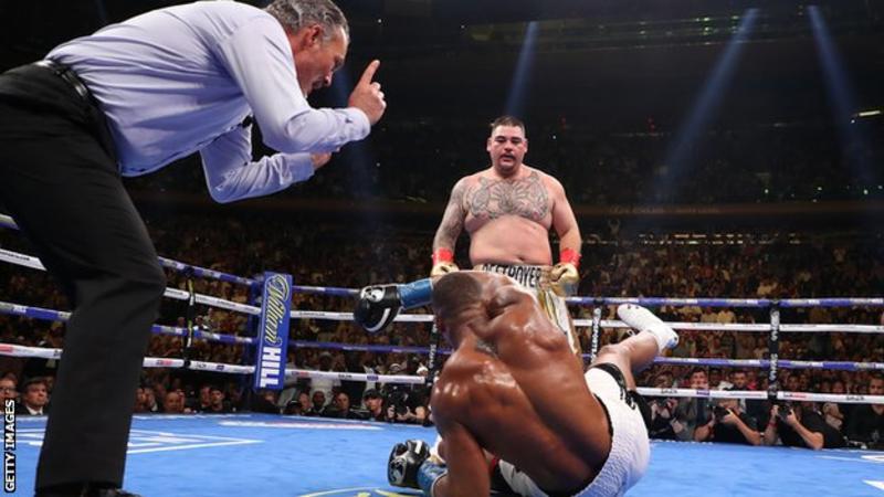 Referee Mike Griffin starts the count after Joshua is floored by his opponent