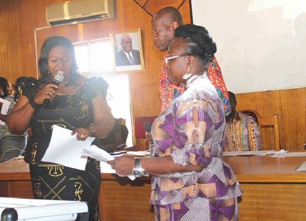 Mrs Kumi-Richardson (left) swearing in Mrs Justina Owusu-Banahene into office