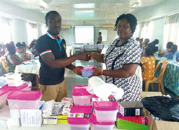 Mrs Beatrice Essilfie presenting a Vero Pack to Mr Michael Essumang at the training programme