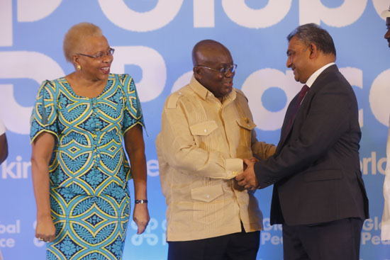President Akufo-Addo interacting with Dr Vasu Gounden (right), Founder and Executive Director, Global Peace. Looking on is Mrs Graca Machel (left), Chairperson of Global Peace in Accra..jpg