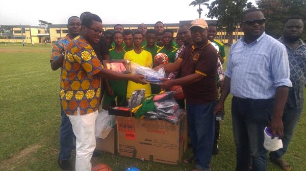 Mr Isaac Adjei-Mensah (left) presenting the sports items to the Headmaster of St Peter's SHS, Mr Mathias Kudiabor