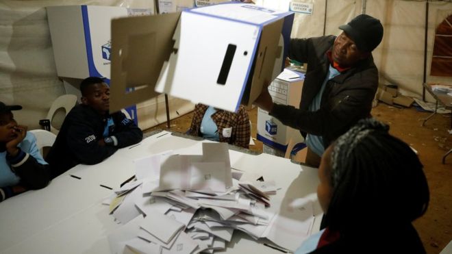  An election official empties a ballot box as counting begins in Johannesburg 