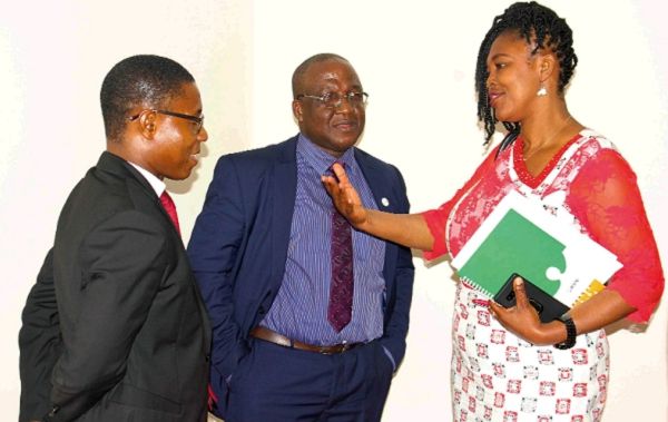 Mrs Abena Adubea Amoah Acheampong (right), holding discussions with Dr Robert Kwesi Mensah (middle) UNFPA, Mr Gideon Leckson Leckey (left), National Treasurer, PPAG after the opening ceremony. Picture: Maxwell Ocloo