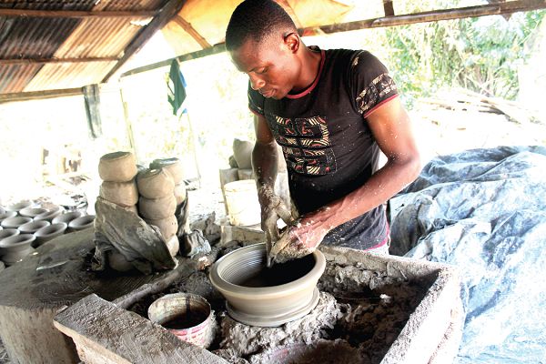 A producer, Mr Kwasi Morrison, moulding an ayowa