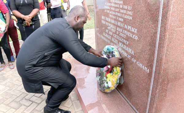 The Minister of Youth and Sports, Isaac Asiamah, laying the wreath