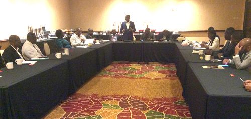 Mr John Peter Amewu (standing) addressing some of the bidders at the meeting.  Fourteen companies bid for the five blocs made available by the government.