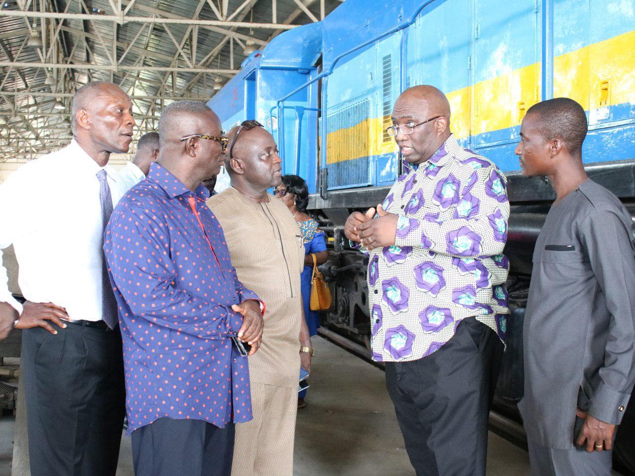 Mr Joe Ghartey (2nd right) in a discussion with Mr Yaw Owusu (in brown outfit) and some officials of the Ghana Railway Development Authority during a tour of the railway workshop at the Tema Port.